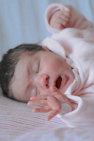 portrait of a baby, not long after birth, they're yawning