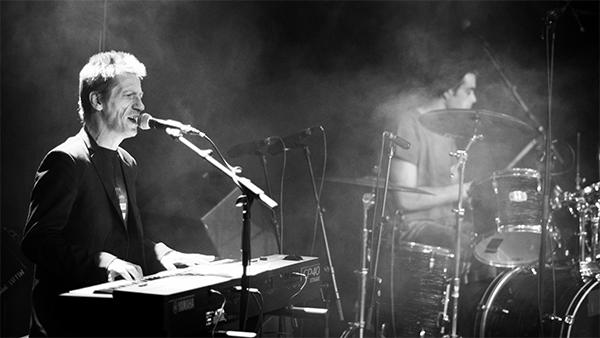 photo of a pianist and a drummer on stage