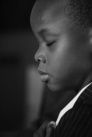 portrait of a kid, from the side, eyes closed, black & white