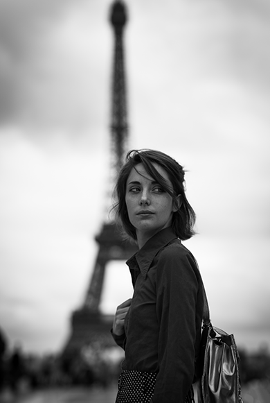 portrait of woman in front of the Eiffel tower, black & white