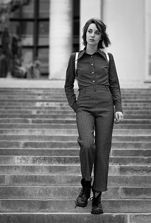 portrait of a woman on a set of stairs, black & white