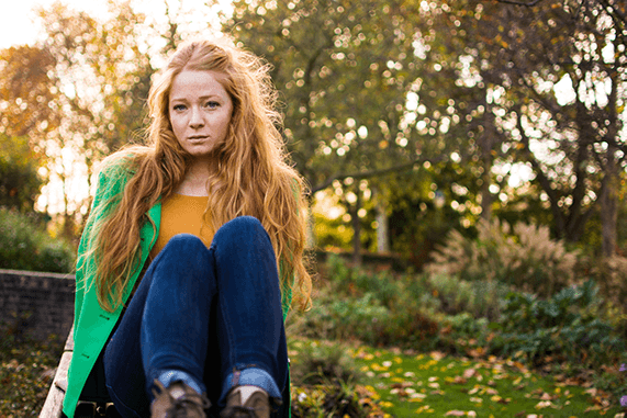 portrait of a women in a parc by fall