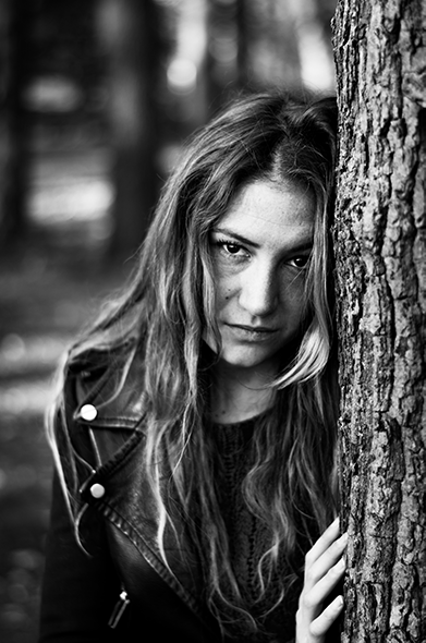 portrait of woman against a tree, black & white